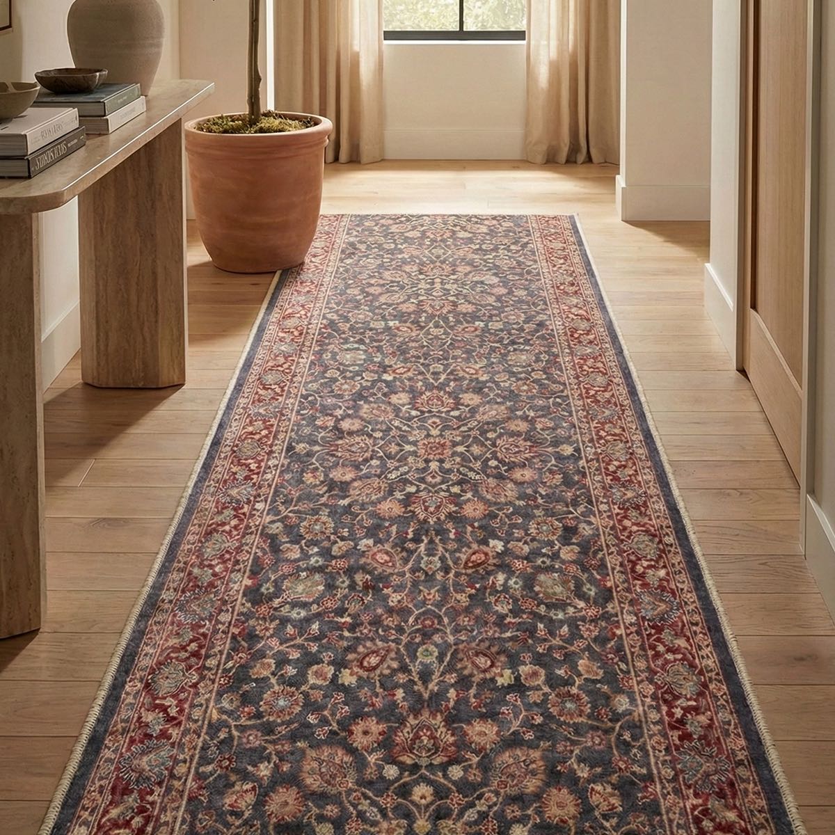 Traditional floral runner rug in entryway with wood floors. The runner is Asha  Rome Navy Blue Red from Well Woven.