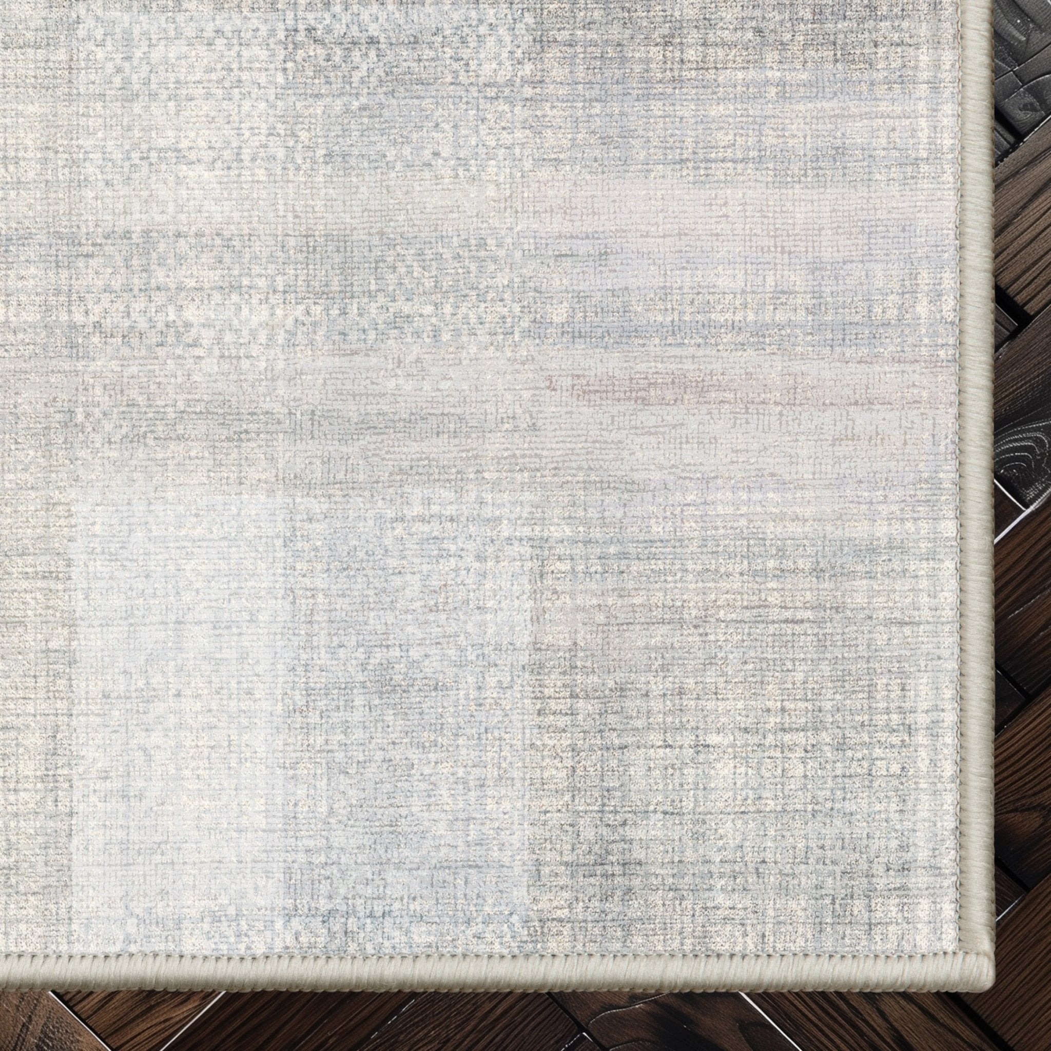 Well Woven - Penda Custom Rug - Cream and Light Grey rug corner on a dark wood floor