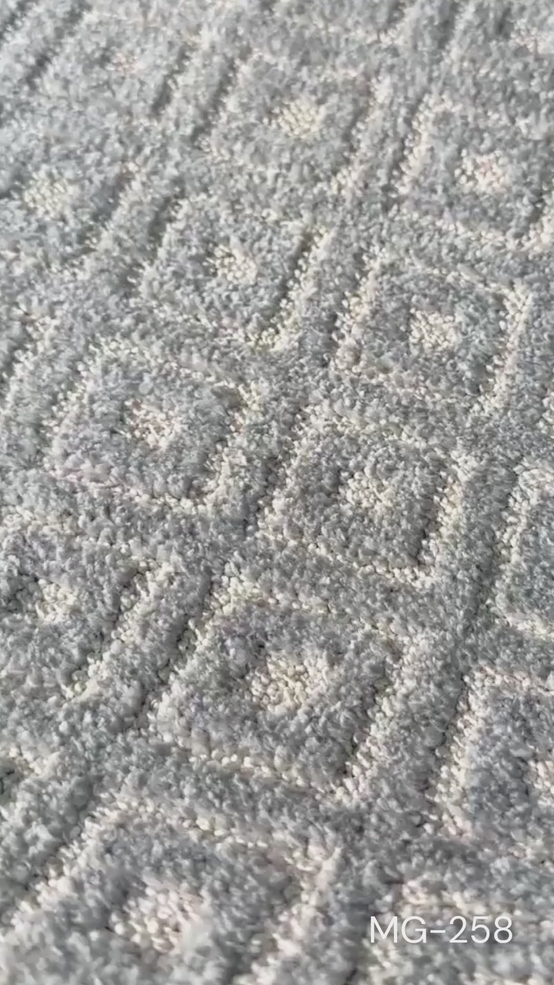 Close up b-roll of a grey and ivory diamond patterned runner rug (MG-258)