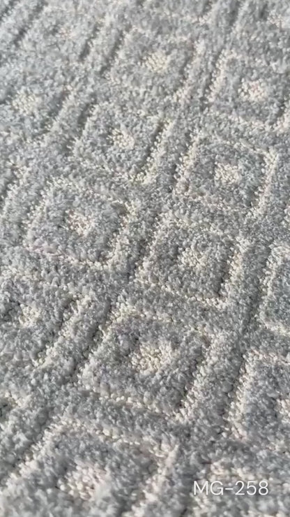 Close up b-roll of a grey and ivory diamond patterned runner rug (MG-258)
