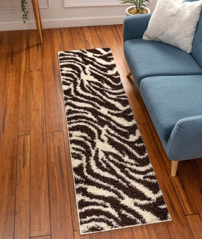 Safari Zebra Brown Contemporary Shag Rug - Well Woven - brown and white runner rug extending down a hallway with warm wood flooring and a blue sofa.