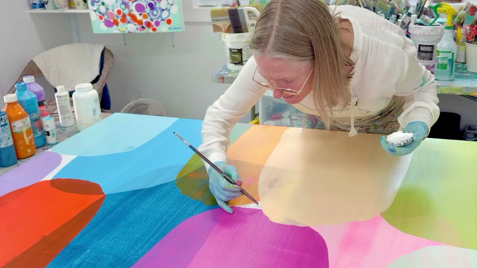 Claire Desjardins painting in her studio.