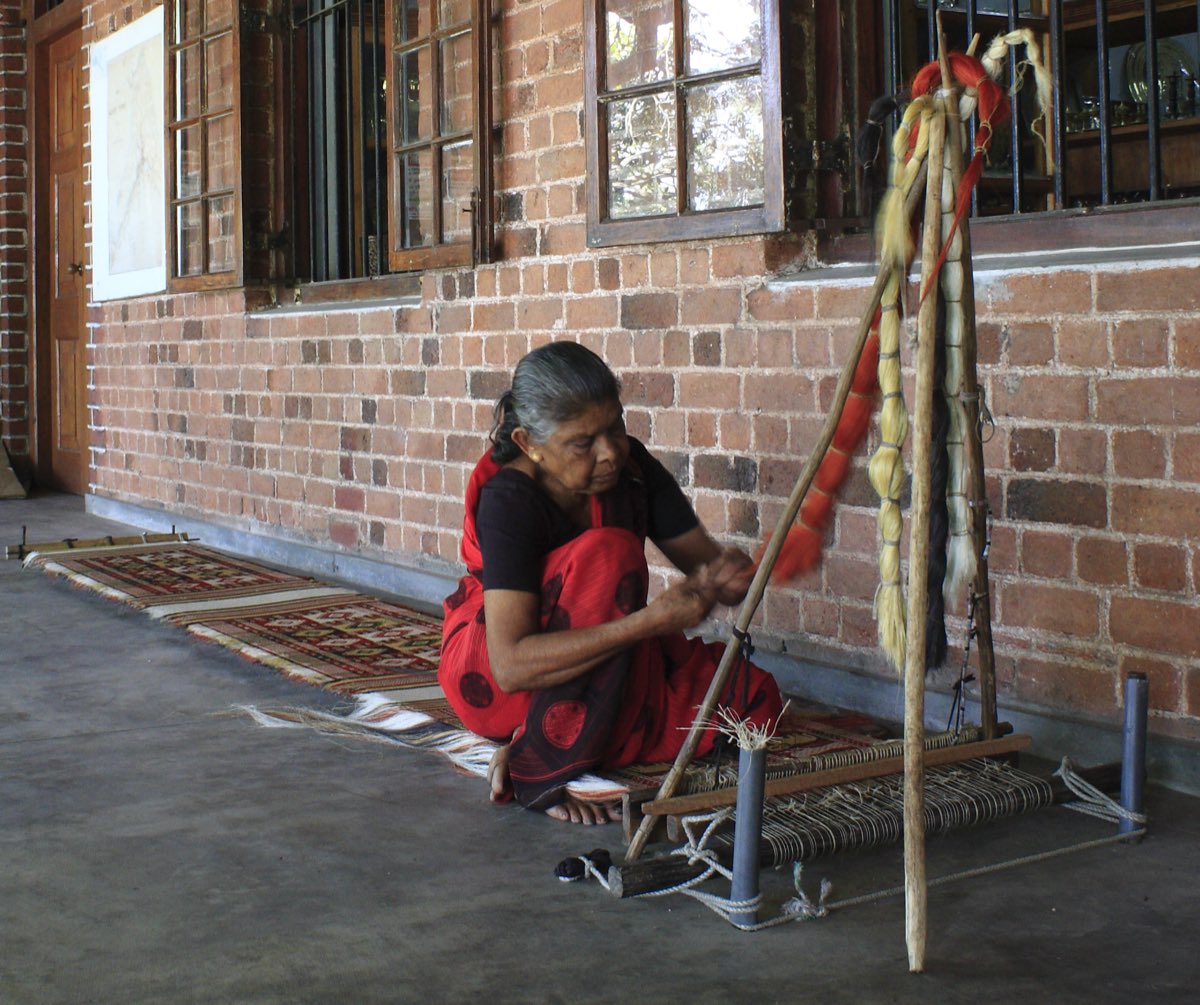 Fiber threads being worked through a Dumbara weaving loom in the Kandy region of Sri Lanka.