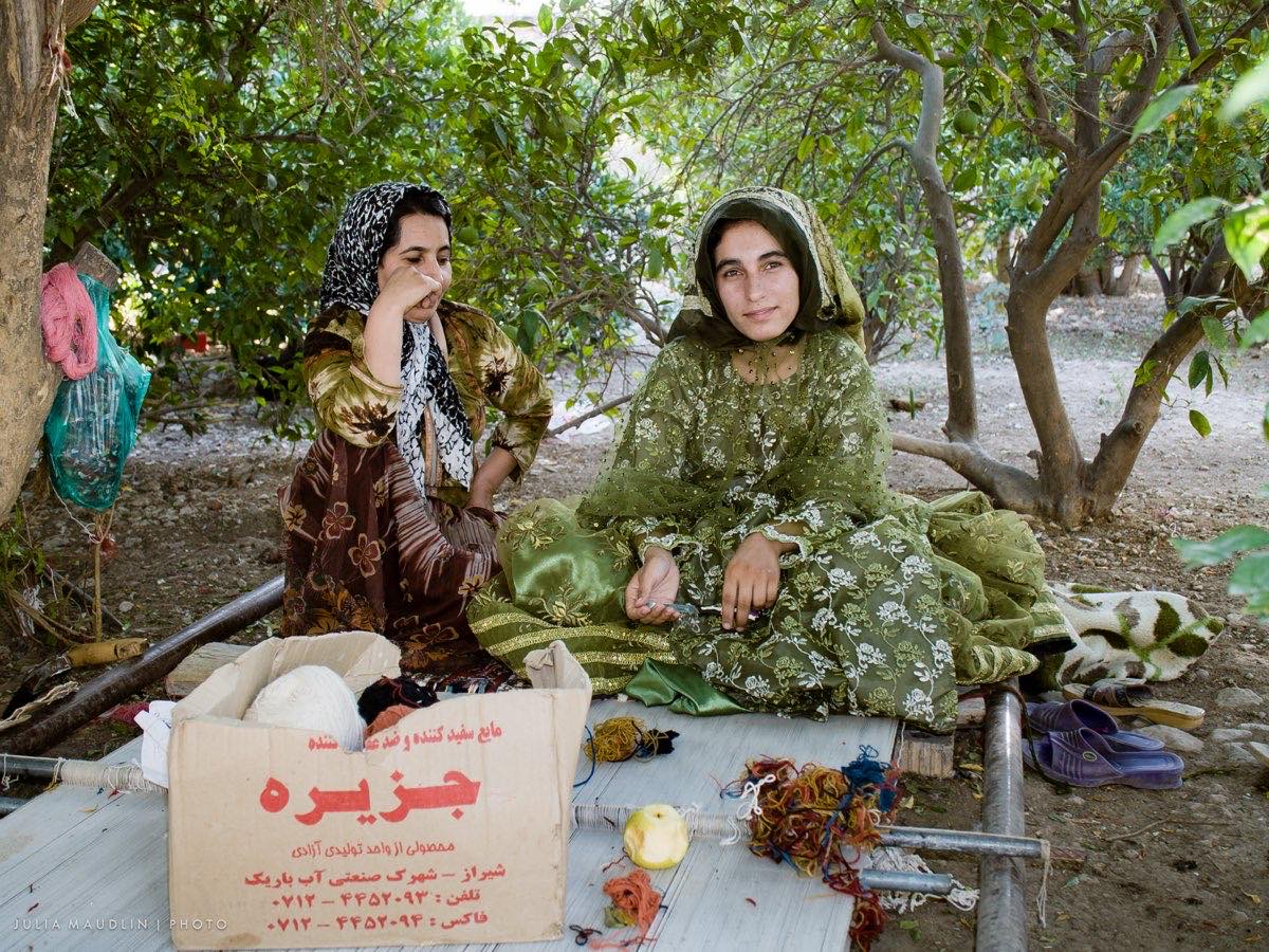 Qashqai weavers seated at their floor loom near Firuzabad, Fars Province, Iran.