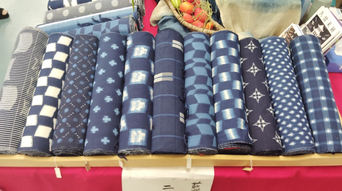 Bolts of Kurume-gasuri — deep indigo cotton scattered with white resist-dyed motifs — in Hirokawa, the craft's home region.