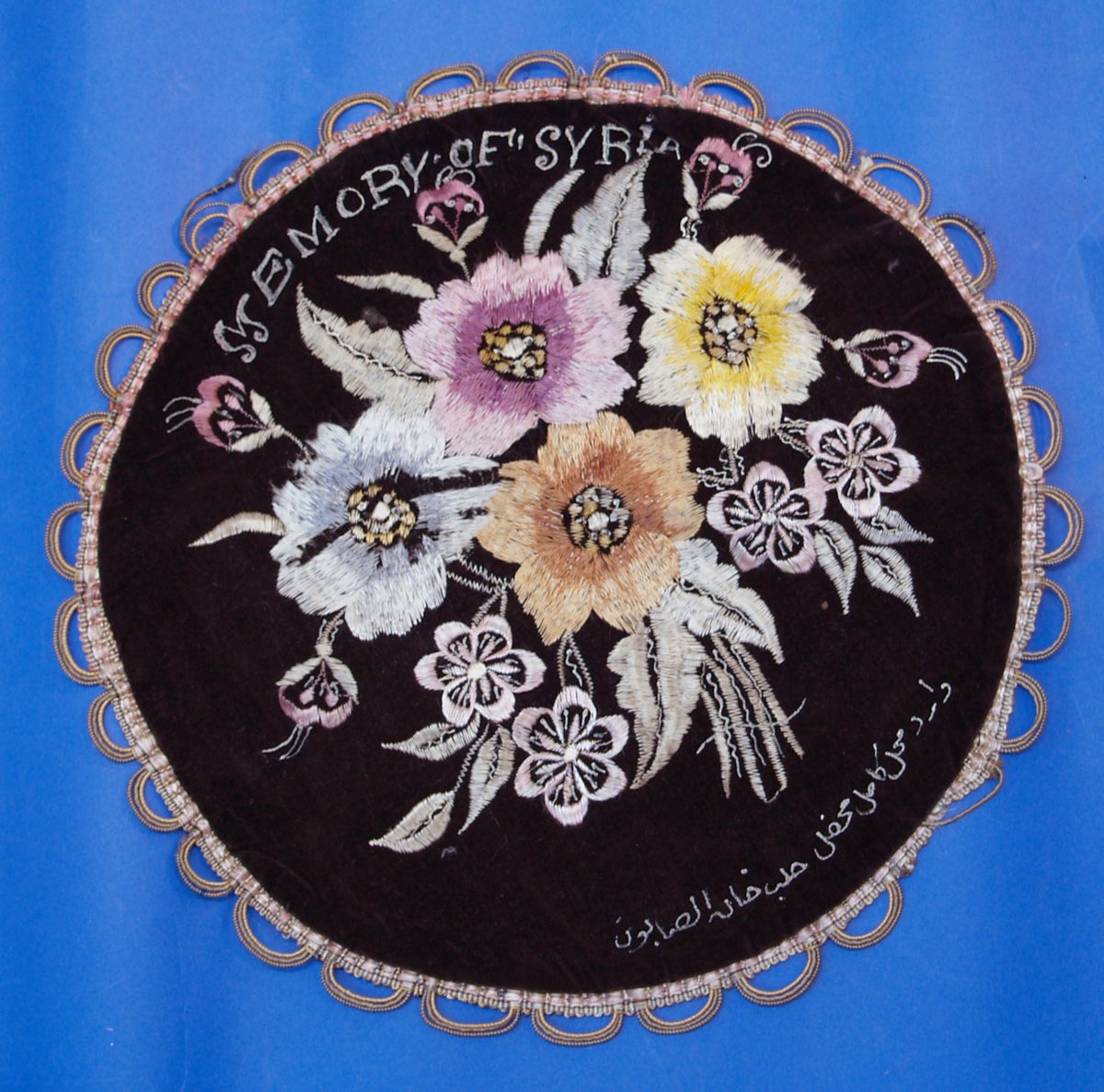 A Syrian embroidered souvenir cloth from around 1940, stitched “Memory of Syria” — needlework of the same family as tarbit.