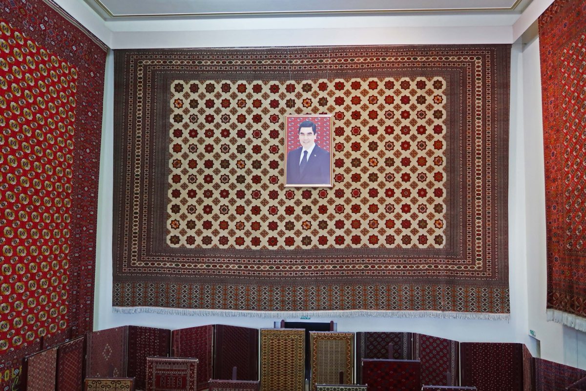 A hand-knotted Turkmen carpet at the national Carpet Museum in Ashgabat, its gul medallions repeating like a signature.
