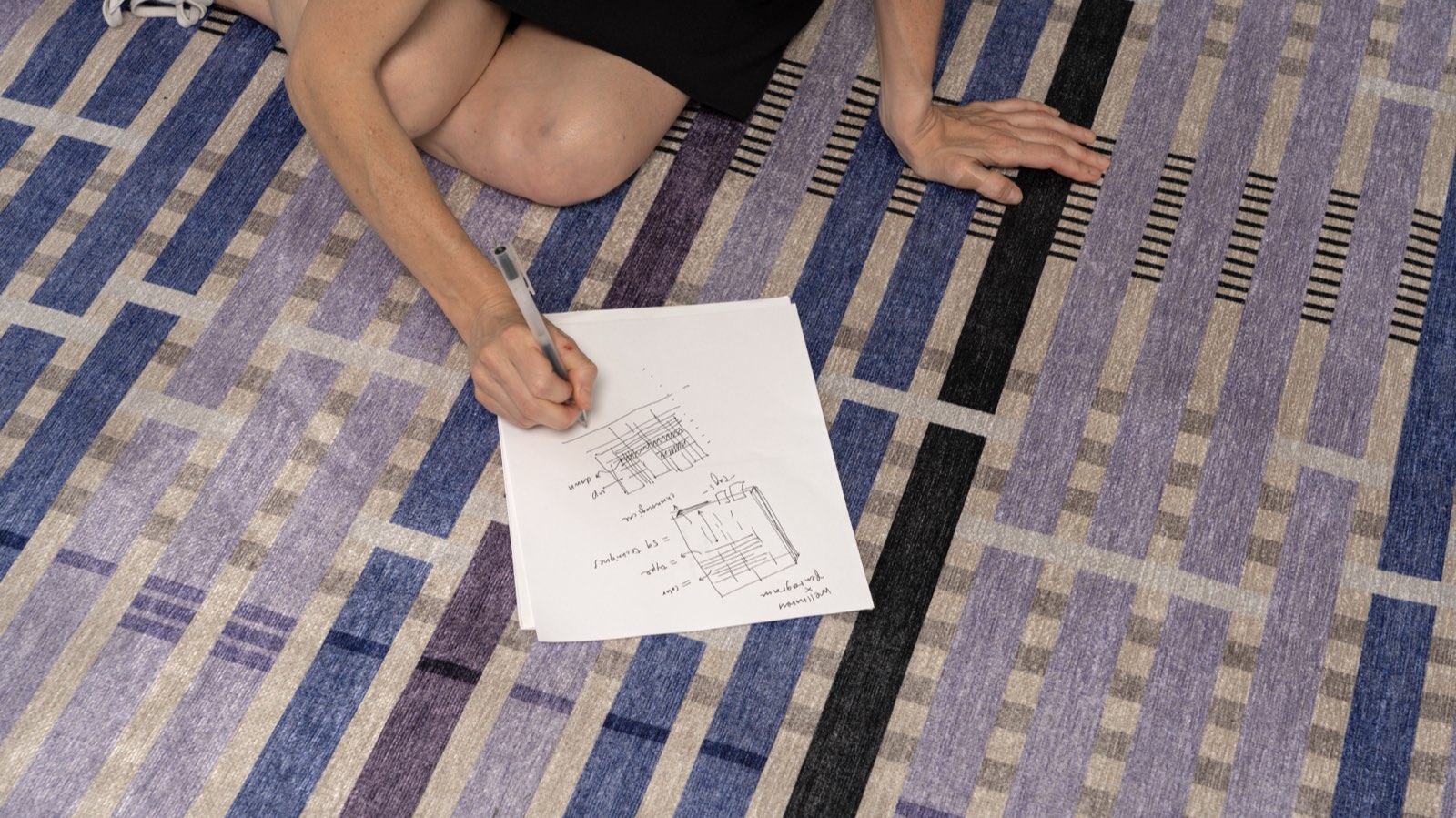 Giorgia Lupi sketching on the Unraveling Stories rug